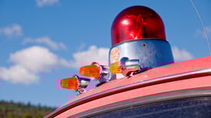 A red siren light on the roof of a car A red siren light on the roof of a car