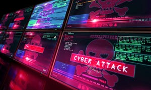 Rows of computer monitors with skulls and crossbones indicating a cyberattack