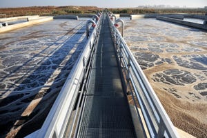 A water treatment facility with a walkway in the middle and water on each side