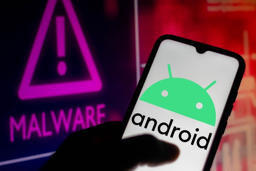 hand holding an android phone with android logo, against the backdrop of a screen that says "malware"