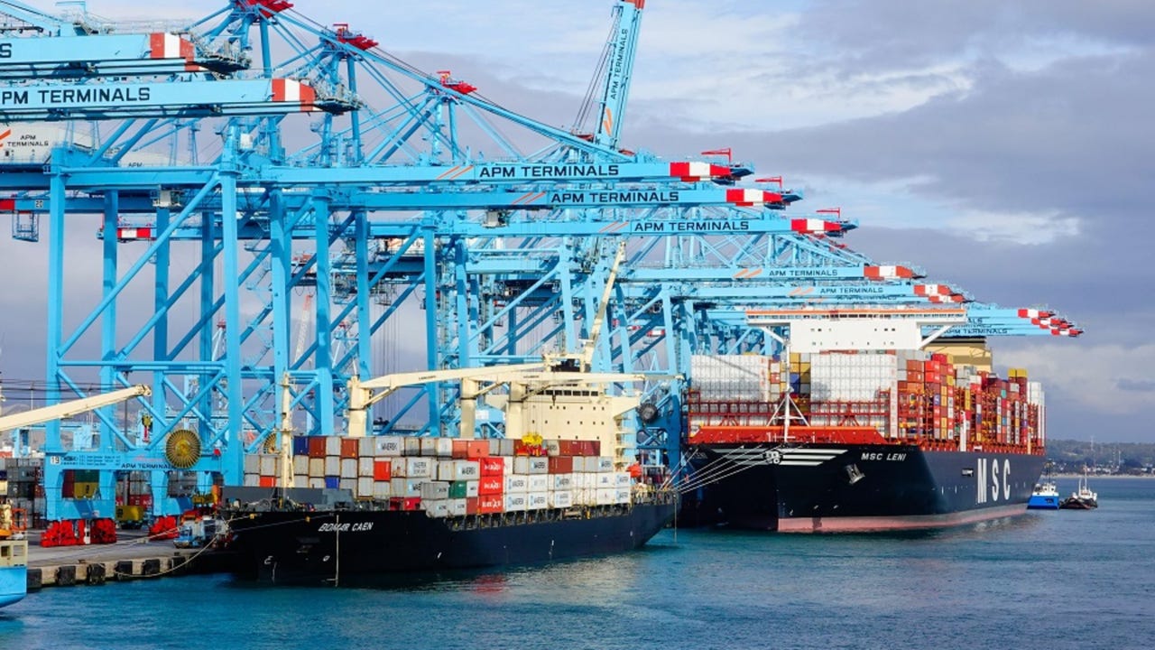 Two container ships side by side in a port Two container ships side by side in a port