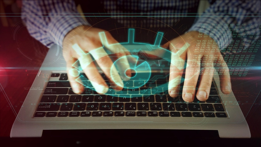 Hands on a laptop with digital eye superimposed over the hands