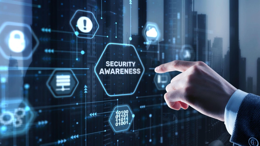 Man's hand points toward the words "SECURITY AWARENESS" on a screen; there are security-related icons around it. 