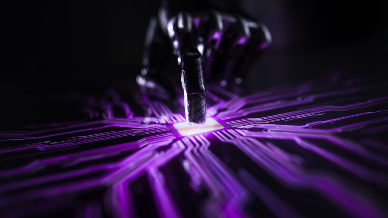 A robot hand touching a glowing chip A robot hand touching a glowing chip