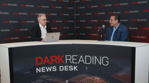Two people talking at a news desk against a dark backdrop with "Dark Reading" written on it. Two people talking at a news desk against a dark backdrop with "Dark Reading" written on it.