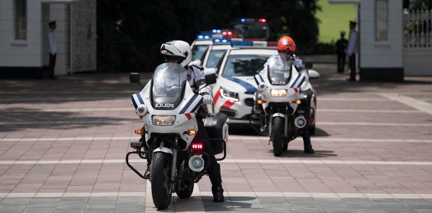 Singapore police officers on motorcycles and in cars