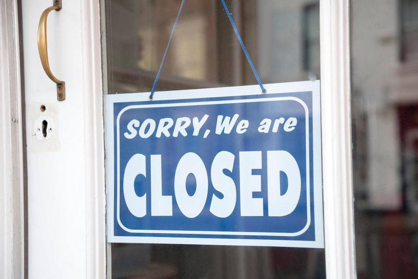 A blue and white sign on a window that reads, A blue and white sign on a window that reads,