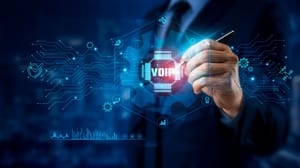 A suited figure holding up a chip with the letters VoIP on it. A suited figure holding up a chip with the letters VoIP on it.
