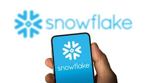 Snowflake company logo displayed on smartphone that a person's hand is holding Snowflake company logo displayed on smartphone that a person's hand is holding