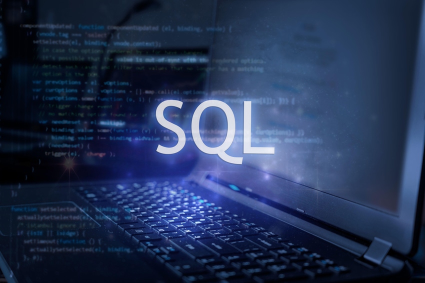 Letters "SQL" over a background image of a laptop, to illustrate the programming language