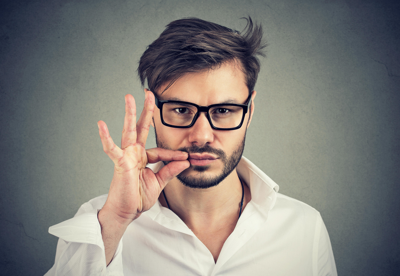 serious man zipping his mouth shut. Quiet, keep a secret concept serious man zipping his mouth shut. Quiet, keep a secret concept