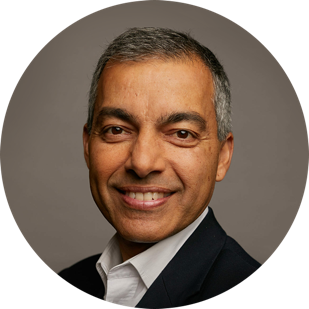 Vikram Sharma, CEO & Founder of QuintessenceLabs, has dark eyes, graying short hair, and a nice button-down