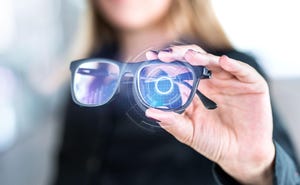 Photo illustration of smart glasses concept, a woman holding a pair of glasses with a cyber-style overlay