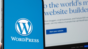 WordPress logo displayed on a mobile device next to WordPress homepage displayed on a computer screen WordPress logo displayed on a mobile device next to WordPress homepage displayed on a computer screen