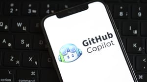 GitHub Copilot's logo on an iPhone screen, laying on a keyboard GitHub Copilot's logo on an iPhone screen, laying on a keyboard