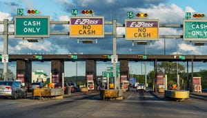 Toll booth on highway; signs saying "Cash Only" and "EZ-Pass No Cash"