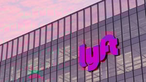 Lyft Signage Logo on Top of Glass Building. Workplace Transport Company Office lit by pink sunset. Lyft Signage Logo on Top of Glass Building. Workplace Transport Company Office lit by pink sunset.