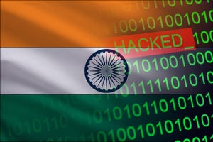Binary code and the word hacked against a backdrop of the Indian flag