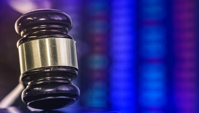 Photo of a judge's gavel against a blurred background
