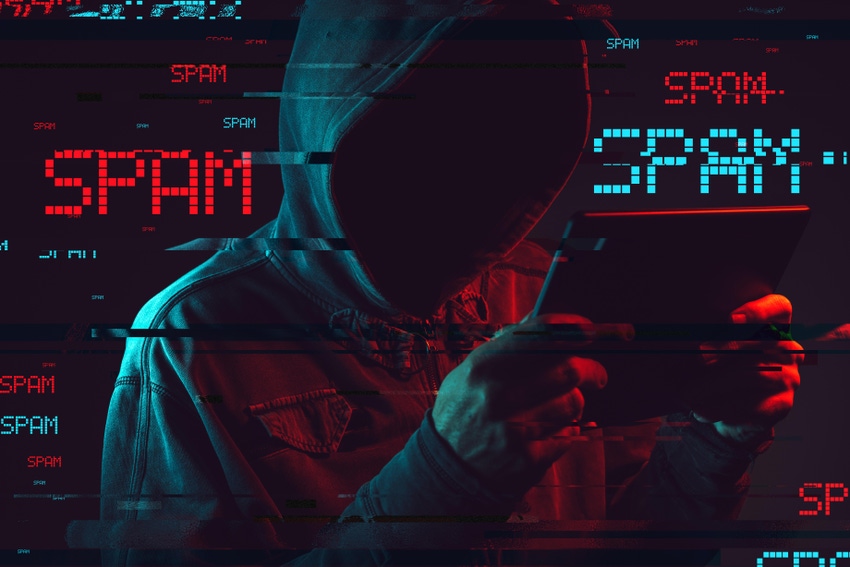 A hooded threat actor holding a device with the word spam written all around them