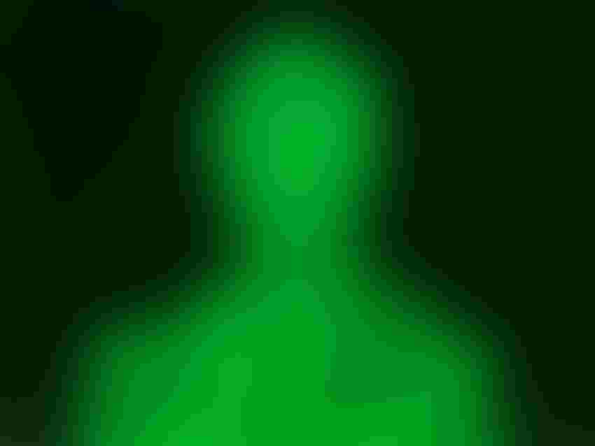 Silhouette of a person's head in green 0 and 1 against a black background.