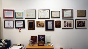 An Ego Wall, a collection of awards, diplomas, and certificates