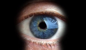 Blue eye looking through a keyhole
