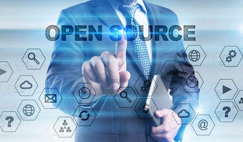 The torso of someone in a business suit with their finger pressing the words "open source" surrounded by tech icons