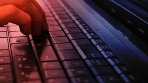 A person's hand on a computer keyboard A person's hand on a computer keyboard