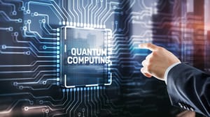A hand pointing to a large computer chip with the words "quantum computing" on it A hand pointing to a large computer chip with the words "quantum computing" on it