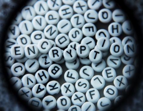 Letter tiles in a pile, with the top ones spelling out the word, "Encryption"