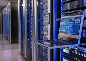 Photo of a datacenter full of servers, with a laptop open to control things