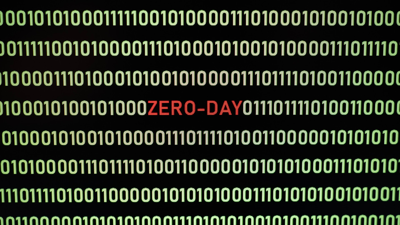 Red ZERO-DAY text amid yellow binary code Red ZERO-DAY text amid yellow binary code