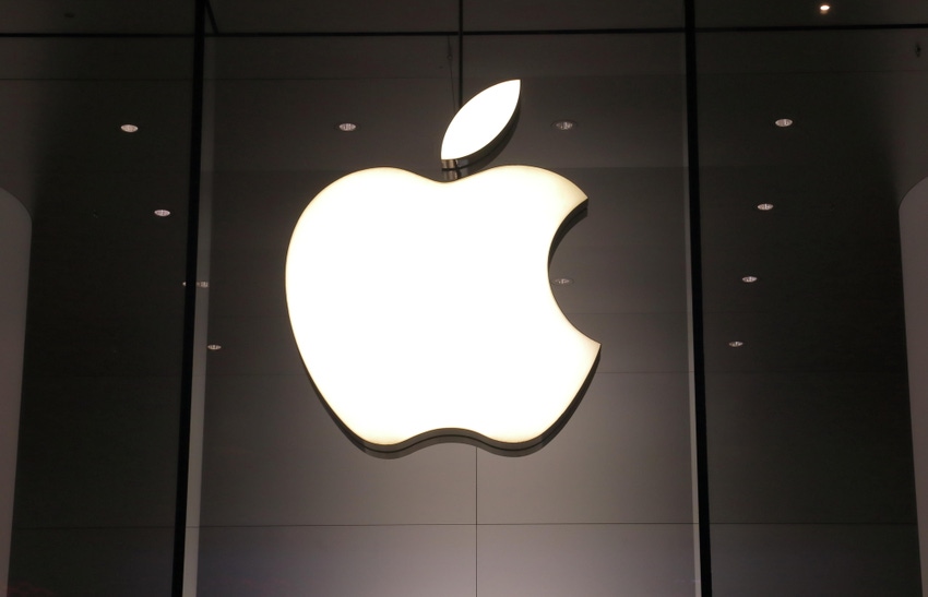 Apple computer logo on darkened office window