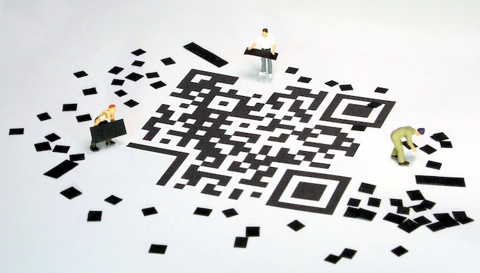 Workers build a QR code