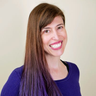 Tanya Janca, founder and CEO of We Hack Purple, has long brown hair with purple tips and wears a deep purple shirt