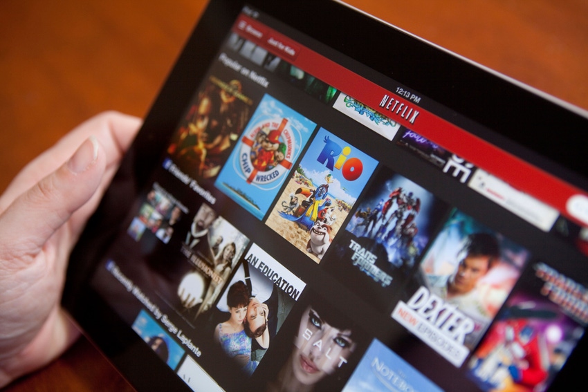 A woman uses the Netflix app on an iPad 4
