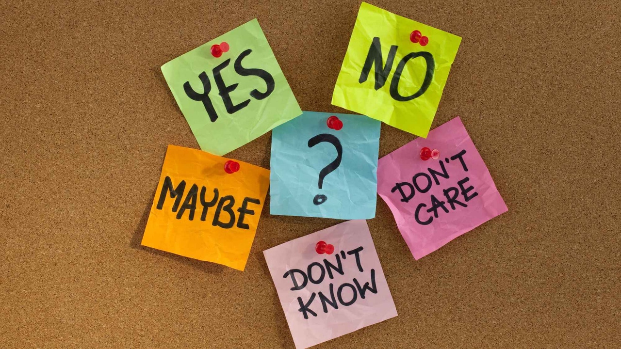 A corkboard with six post-it notes of various colors saying A corkboard with six post-it notes of various colors saying