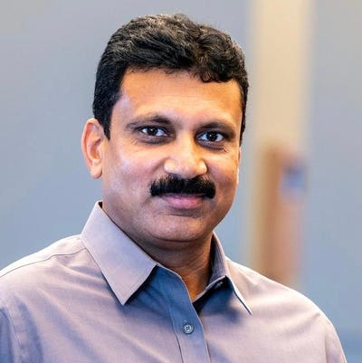 Shashidhar Angadi, CTO of Exterro, has short black hair, a mustache, and wears a blue button-down shirt
