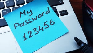 A blue sticky note that reads "My password: 123456" on the keyboard of a MacBook