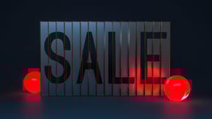 The word Sale printed on binders in a dimly lit box, with red lights lying around for color The word Sale printed on binders in a dimly lit box, with red lights lying around for color