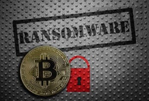 A Bitcoin in front of a metal background with a red lock and the word "ransomware" across it
