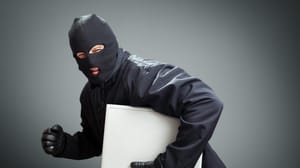Thief in ski mask running away with laptop Thief in ski mask running away with laptop