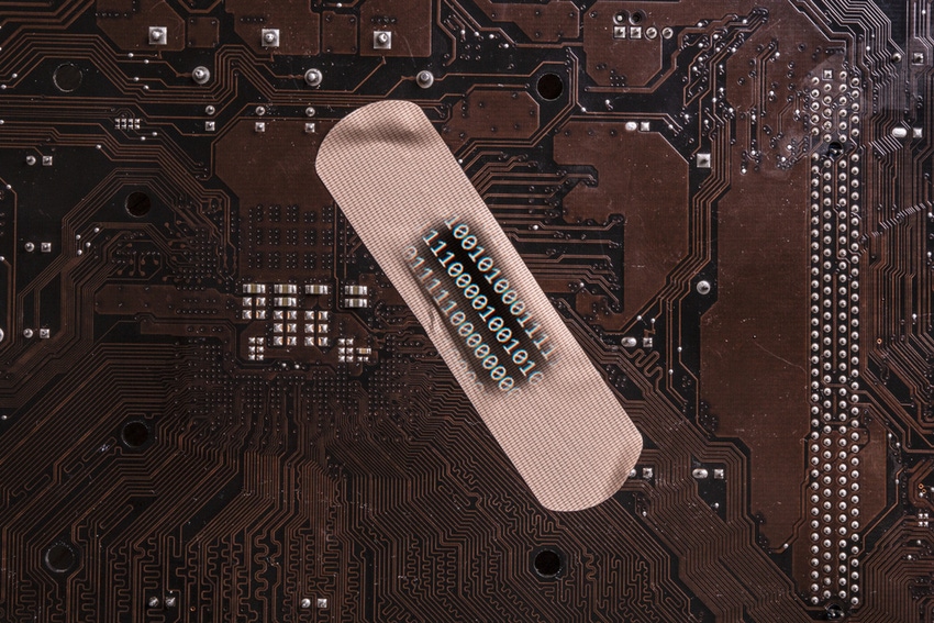A bandaid on top of a piece of computer hardware with lines of code superimposed on top of it A bandaid on top of a piece of computer hardware with lines of code superimposed on top of it