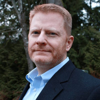 Chuck Randolph, chief security officer at Ontic, has short red hair and beard. He wears a light blue oxford and navy blazer