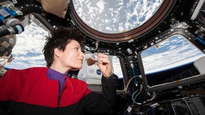 Astronaut Samantha Cristoforetti of European Space Agency wears a Star Trek uniform on the International Space Station, with Earth behind her
