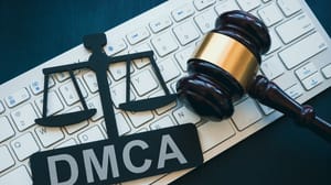DMCA logo and gavel sitting on a computer keyboard DMCA logo and gavel sitting on a computer keyboard
