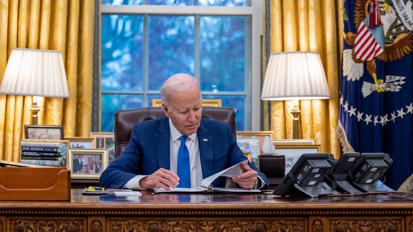 US President Joe Biden at his desk in the White House reads his script ahead of a speech