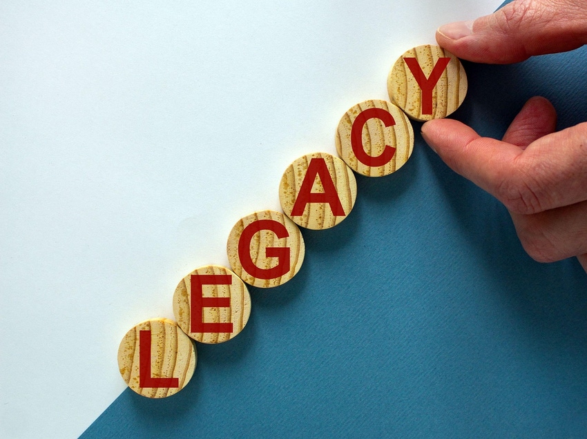 The word "legacy" on round wooden tiles