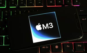Closeup of mobile phone with logo lettering of Apple M3 chip on computer keyboard